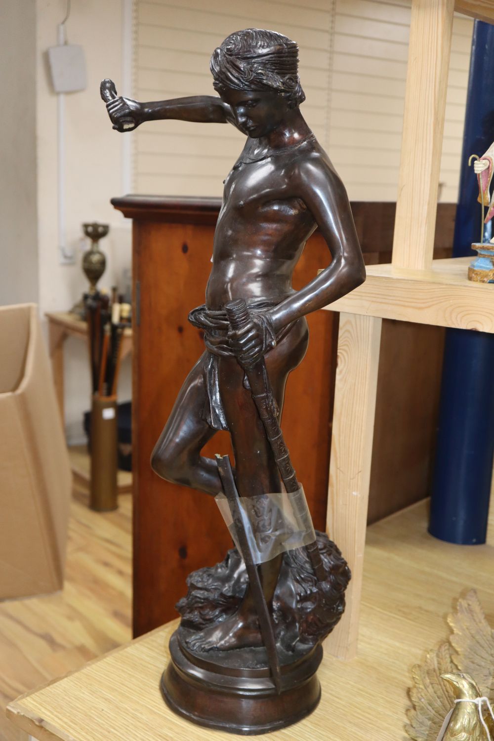 After Antonin Mercie. A modern bronze of David having defeated Goliath, height 70cm